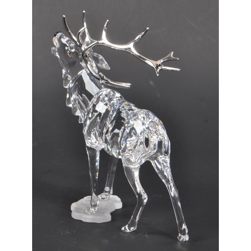 115 - Swarovski - A crystal glass Swarovski figurine / ornament in the form of a stag 291431 in standing p... 