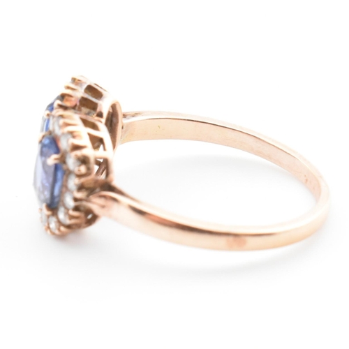 1 - A rose gold, sapphire and diamond double cluster ring. The vintage ring having two four claw set ova... 