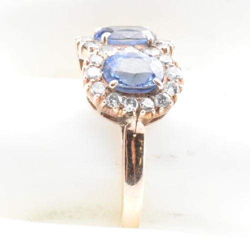 1 - A rose gold, sapphire and diamond double cluster ring. The vintage ring having two four claw set ova... 