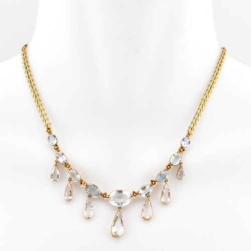 101 - A Victorian gold and aquamarine fringe necklace by Mrs Newman. The necklace having a line of graduat... 