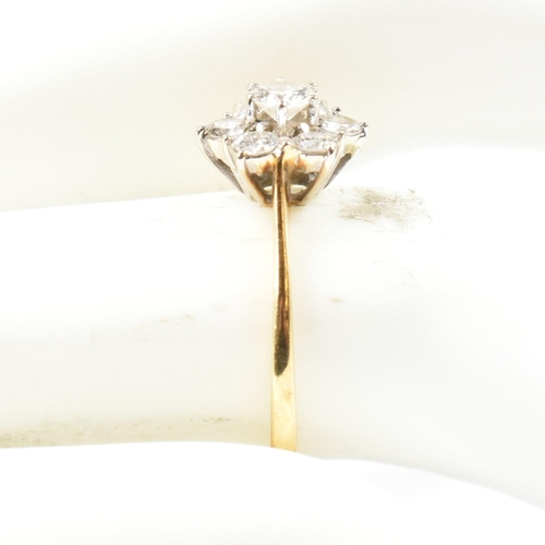 102 - An 18ct gold and diamond cluster ring. The ring set with a central round cut diamond surrounded by a... 