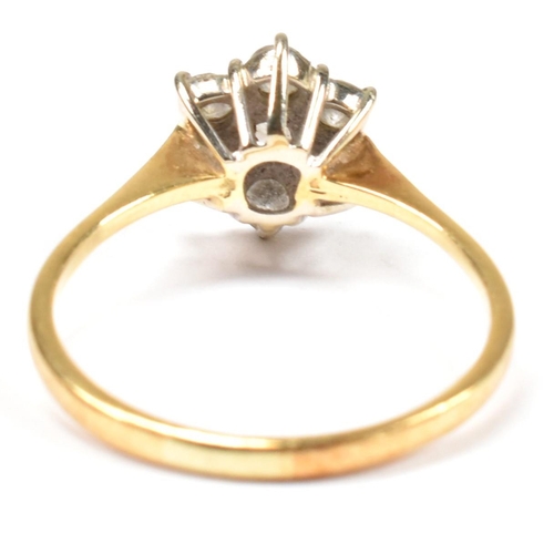 102 - An 18ct gold and diamond cluster ring. The ring set with a central round cut diamond surrounded by a... 