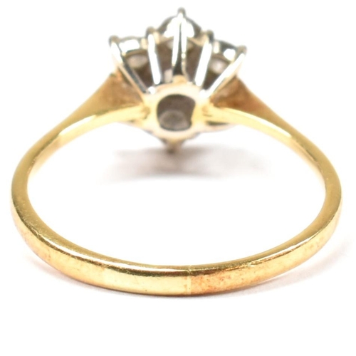 102 - An 18ct gold and diamond cluster ring. The ring set with a central round cut diamond surrounded by a... 