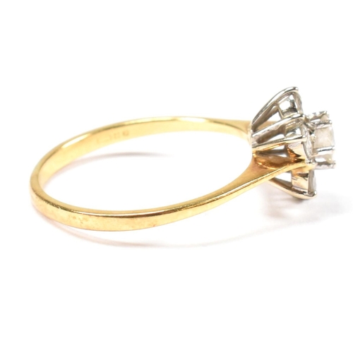 102 - An 18ct gold and diamond cluster ring. The ring set with a central round cut diamond surrounded by a... 