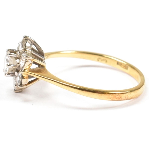 102 - An 18ct gold and diamond cluster ring. The ring set with a central round cut diamond surrounded by a... 