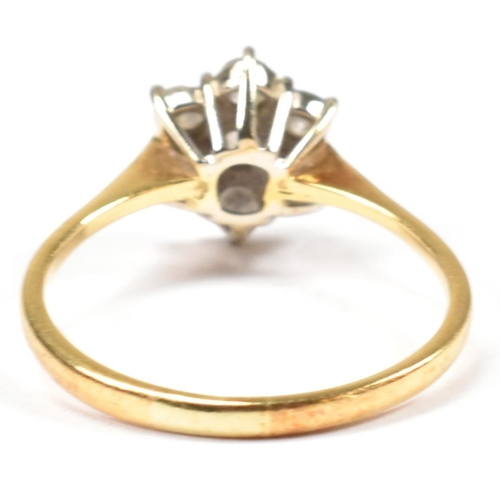 102 - An 18ct gold and diamond cluster ring. The ring set with a central round cut diamond surrounded by a... 