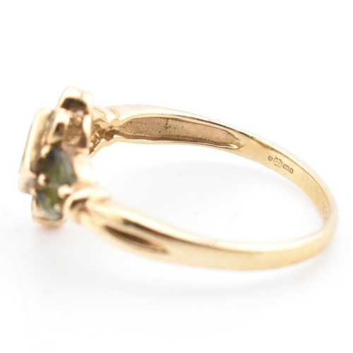 104 - A hallmarked 9ct gold, diamond and green sapphire cluster ring. The ring having a central bezel set ... 