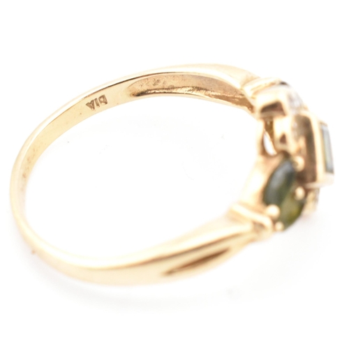 104 - A hallmarked 9ct gold, diamond and green sapphire cluster ring. The ring having a central bezel set ... 