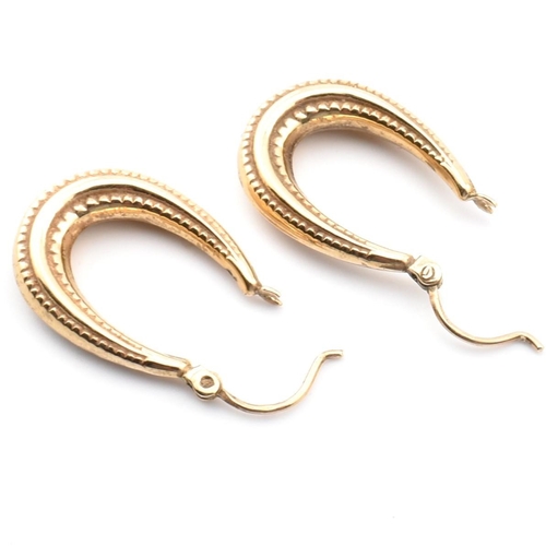 106 - A Victorian hallmarked 9ct gold safety pin together with a pair of 9ct gold hoop earrings. The lot t... 