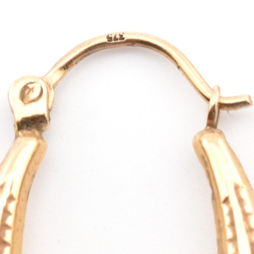 106 - A Victorian hallmarked 9ct gold safety pin together with a pair of 9ct gold hoop earrings. The lot t... 