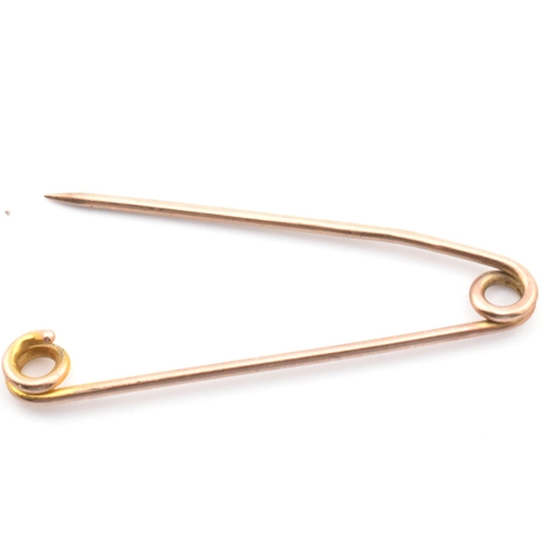 106 - A Victorian hallmarked 9ct gold safety pin together with a pair of 9ct gold hoop earrings. The lot t... 