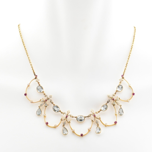 11 - An Edwardian aquamarine, ruby and pearl fringe necklace. The necklace strung with pear cut aquamarin... 