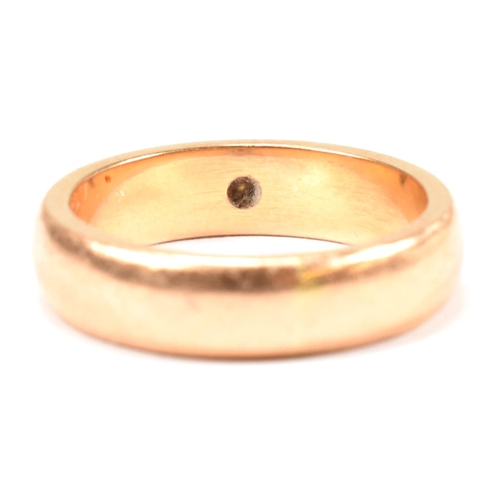 110 - A gold and paste band ring. The band ring having a star set round cut white paste stone. Unmarked ho... 