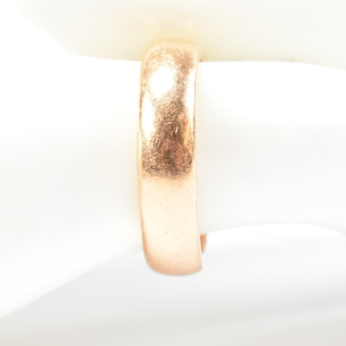 110 - A gold and paste band ring. The band ring having a star set round cut white paste stone. Unmarked ho... 