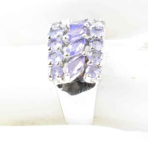 121 - A hallmarked 9ct white gold and purple stone cluster ring. The ring having central row of six marqui... 