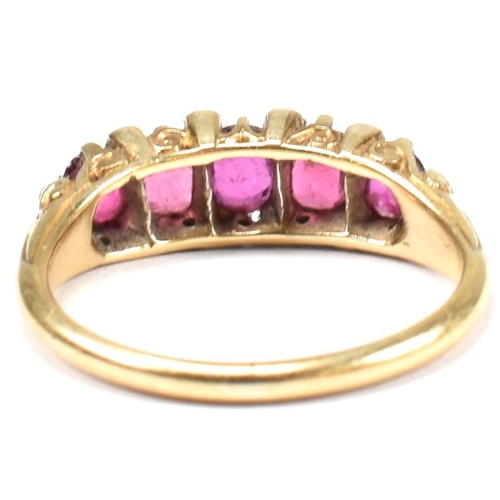 123 - A gold, red stone and diamond five stone ring. The ring having a mixture of mixed cut red stones inc... 