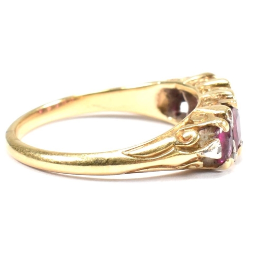 123 - A gold, red stone and diamond five stone ring. The ring having a mixture of mixed cut red stones inc... 