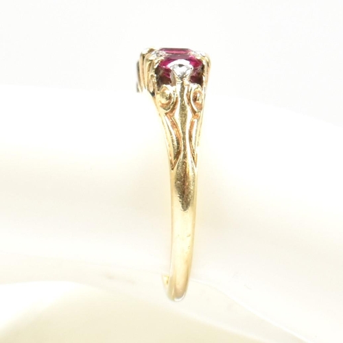 123 - A gold, red stone and diamond five stone ring. The ring having a mixture of mixed cut red stones inc... 