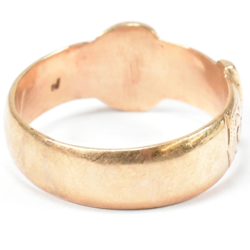 125 - A hallmarked 9ct gold buckle ring. The buckle ring having scrolling bright cut engraved decoration t... 