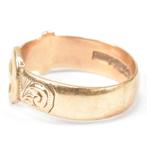 125 - A hallmarked 9ct gold buckle ring. The buckle ring having scrolling bright cut engraved decoration t... 