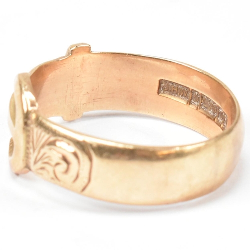 125 - A hallmarked 9ct gold buckle ring. The buckle ring having scrolling bright cut engraved decoration t... 