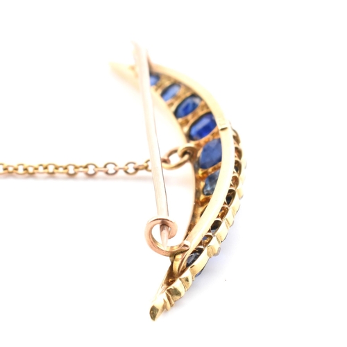 13 - An early 20th century gold, diamond and sapphire crescent brooch pin. The crescent brooch pin set wi... 