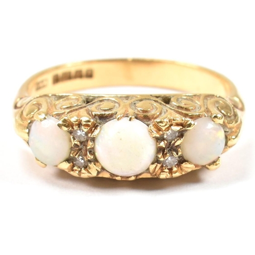 138 - A hallmarked 18ct gold, opal and diamond three stone ring. The 18ct yellow gold ring having with thr... 