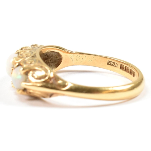 138 - A hallmarked 18ct gold, opal and diamond three stone ring. The 18ct yellow gold ring having with thr... 