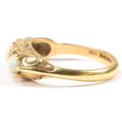 138 - A hallmarked 18ct gold, opal and diamond three stone ring. The 18ct yellow gold ring having with thr... 