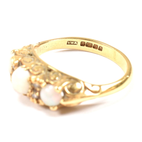 138 - A hallmarked 18ct gold, opal and diamond three stone ring. The 18ct yellow gold ring having with thr... 