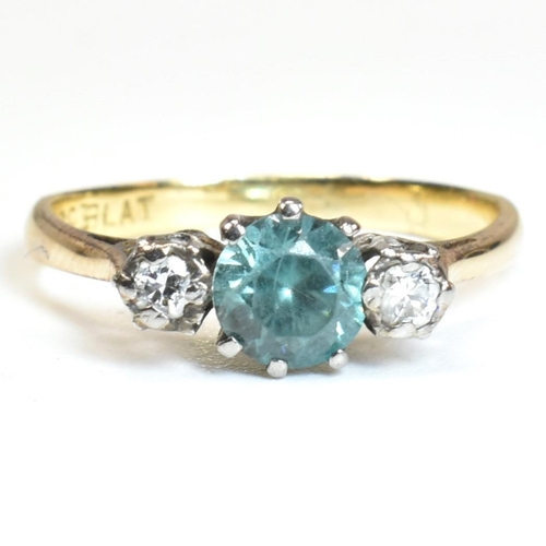 142 - An 18ct gold, zircon and diamond three stone ring. The ring having a central six claw set round cut ... 