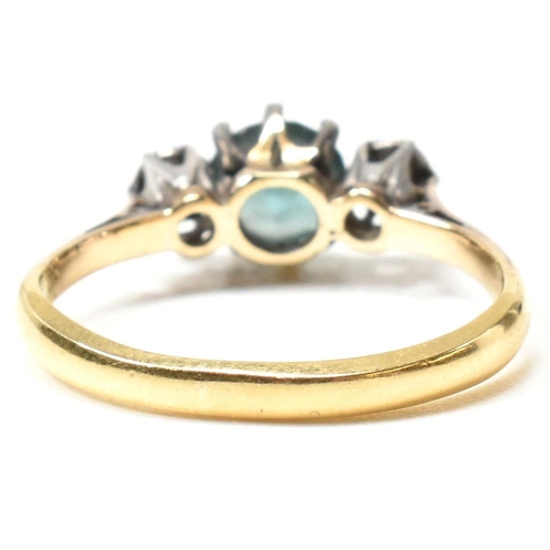 142 - An 18ct gold, zircon and diamond three stone ring. The ring having a central six claw set round cut ... 