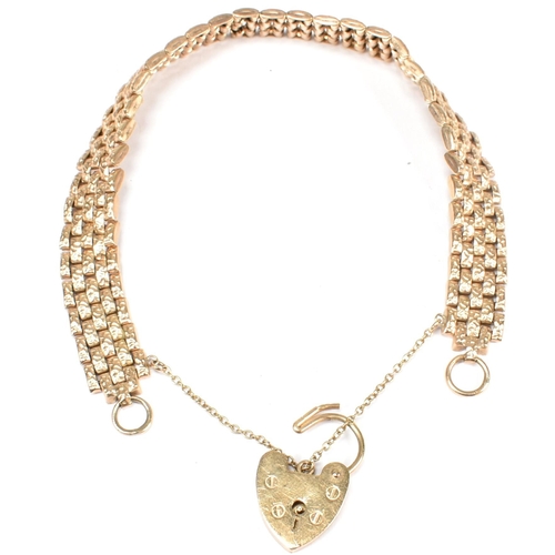 144 - A hallmarked 9ct gold mesh link bracelet with a heart padlock clasp. The hallmarked 9ct gold bracele... 