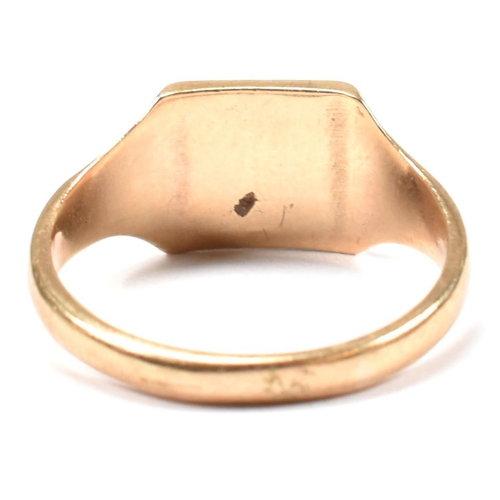 149 - A hallmarked 9ct gold signet ring. The 9ct yellow signet ring having a squared head, half decorated ... 