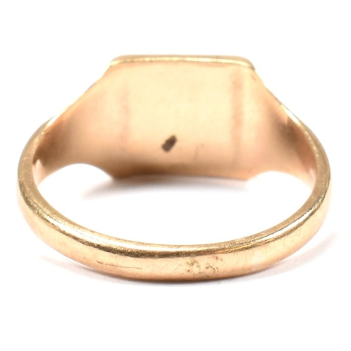 149 - A hallmarked 9ct gold signet ring. The 9ct yellow signet ring having a squared head, half decorated ... 