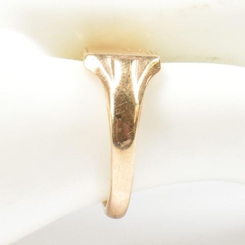 149 - A hallmarked 9ct gold signet ring. The 9ct yellow signet ring having a squared head, half decorated ... 