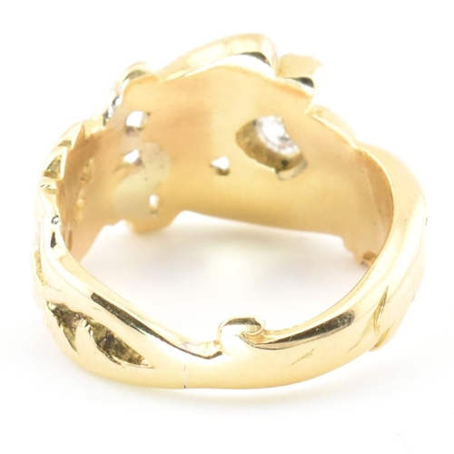 15 - An 18ct gold and diamond Art Nouveau dragon ring. The gold ring having a carved Chinese Qilin design... 