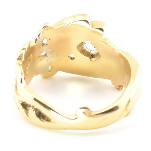 15 - An 18ct gold and diamond Art Nouveau dragon ring. The gold ring having a carved Chinese Qilin design... 