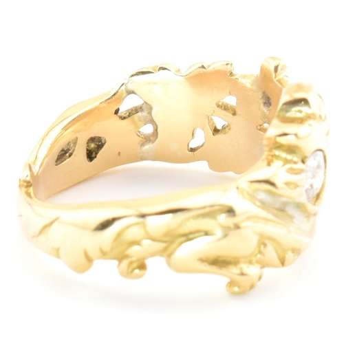 15 - An 18ct gold and diamond Art Nouveau dragon ring. The gold ring having a carved Chinese Qilin design... 