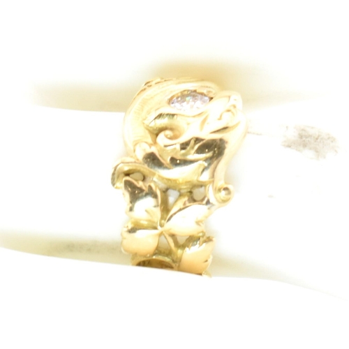 15 - An 18ct gold and diamond Art Nouveau dragon ring. The gold ring having a carved Chinese Qilin design... 