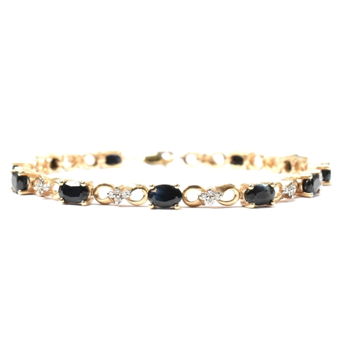 158 - A 9ct gold, sapphire and diamond line bracelet. The 9ct gold bracelet having eleven oval cut sapphir... 