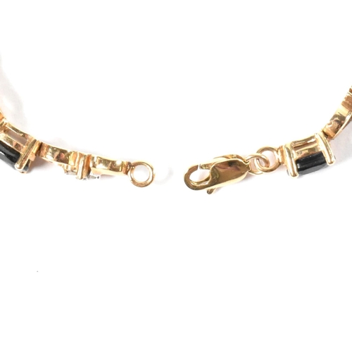 158 - A 9ct gold, sapphire and diamond line bracelet. The 9ct gold bracelet having eleven oval cut sapphir... 