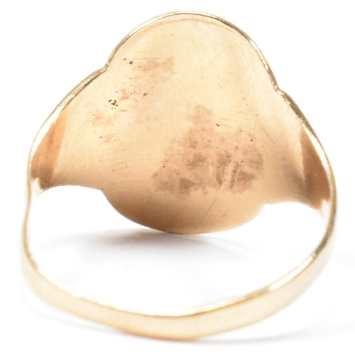 162 - A hallmarked 9ct gold engraved shield ring. The ring having a central oval shaped shield engraved wi... 