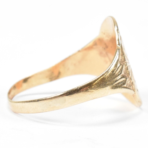 162 - A hallmarked 9ct gold engraved shield ring. The ring having a central oval shaped shield engraved wi... 