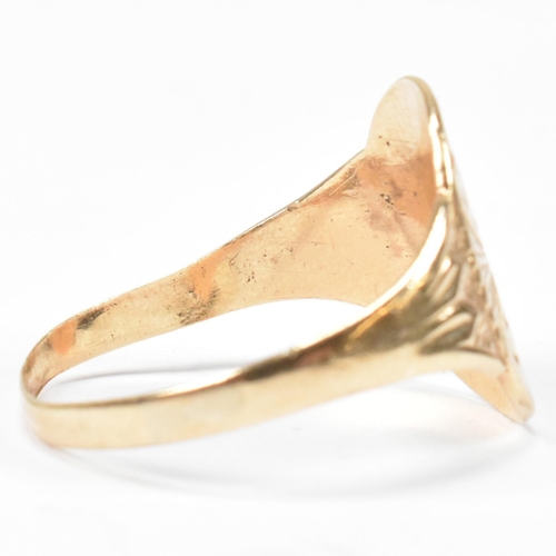 162 - A hallmarked 9ct gold engraved shield ring. The ring having a central oval shaped shield engraved wi... 