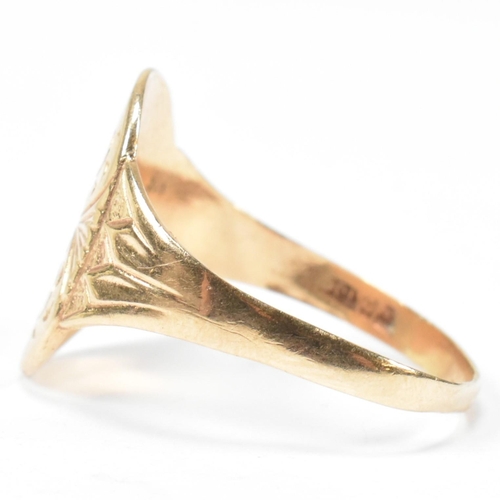 162 - A hallmarked 9ct gold engraved shield ring. The ring having a central oval shaped shield engraved wi... 