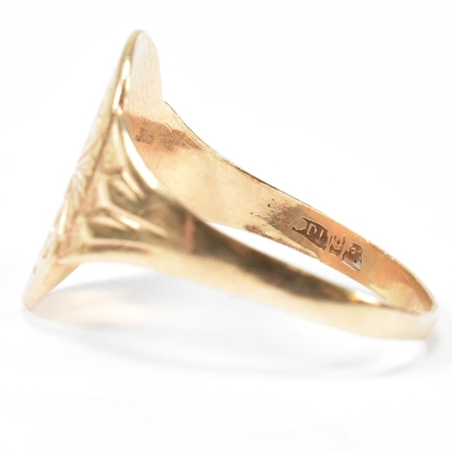 162 - A hallmarked 9ct gold engraved shield ring. The ring having a central oval shaped shield engraved wi... 