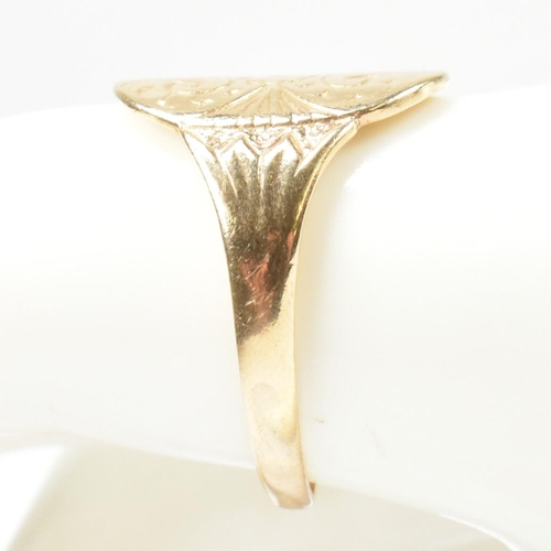 162 - A hallmarked 9ct gold engraved shield ring. The ring having a central oval shaped shield engraved wi... 