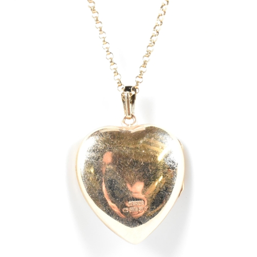 166 - A hallmarked 9ct gold heart locket pendant necklace. The 9ct yellow gold belcher chain necklace stru... 