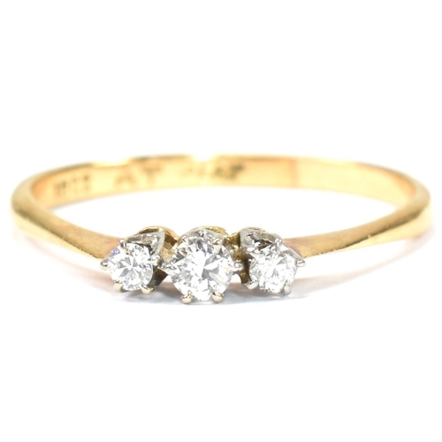 208 - A 18ct gold, platinum and diamond trilogy ring. The ring set with three graduating round cut diamond... 